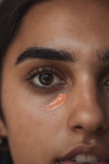 An image of a woman with a stripe of Kauai under her right eye