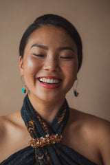 A woman who with radiant skin, smiling